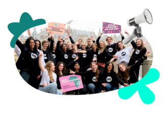 The 2026 Netherlands Youth Ambassadors pose for a photo holding colourful posters.